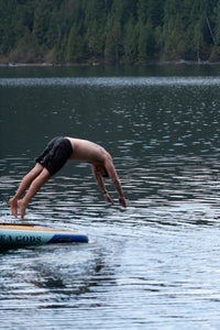 swimmer jumping from inflatable dock